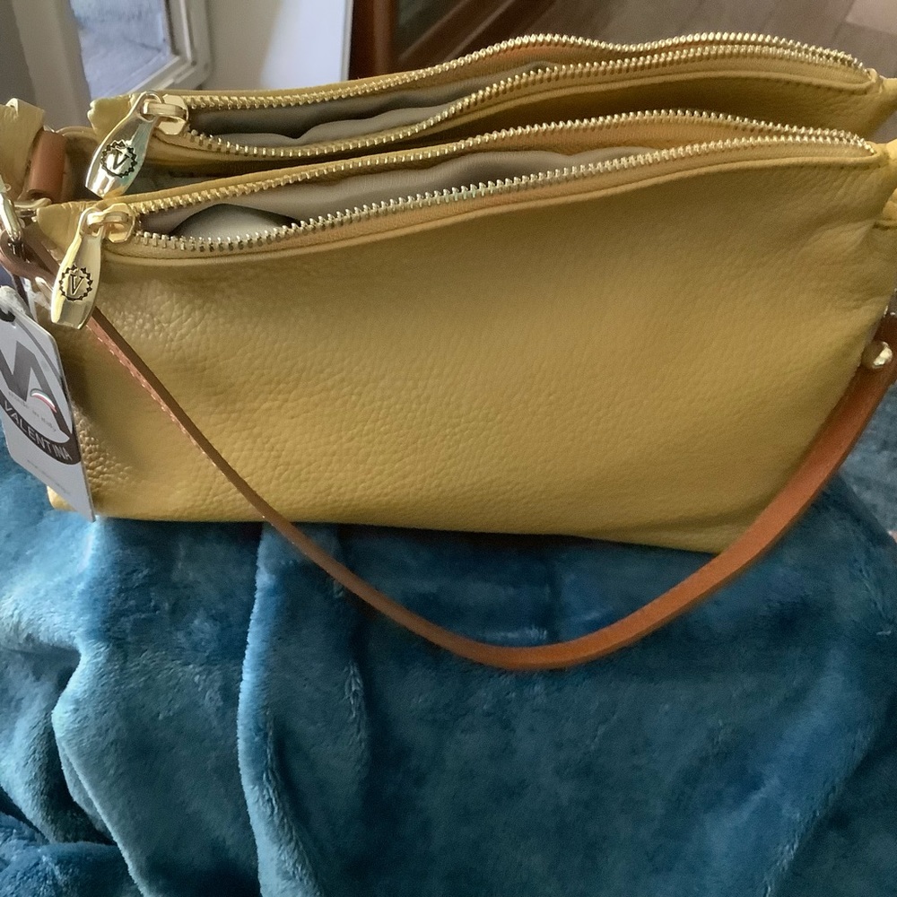 Mustard colored Valentina bag with soft level has extra strap for shoulder bag